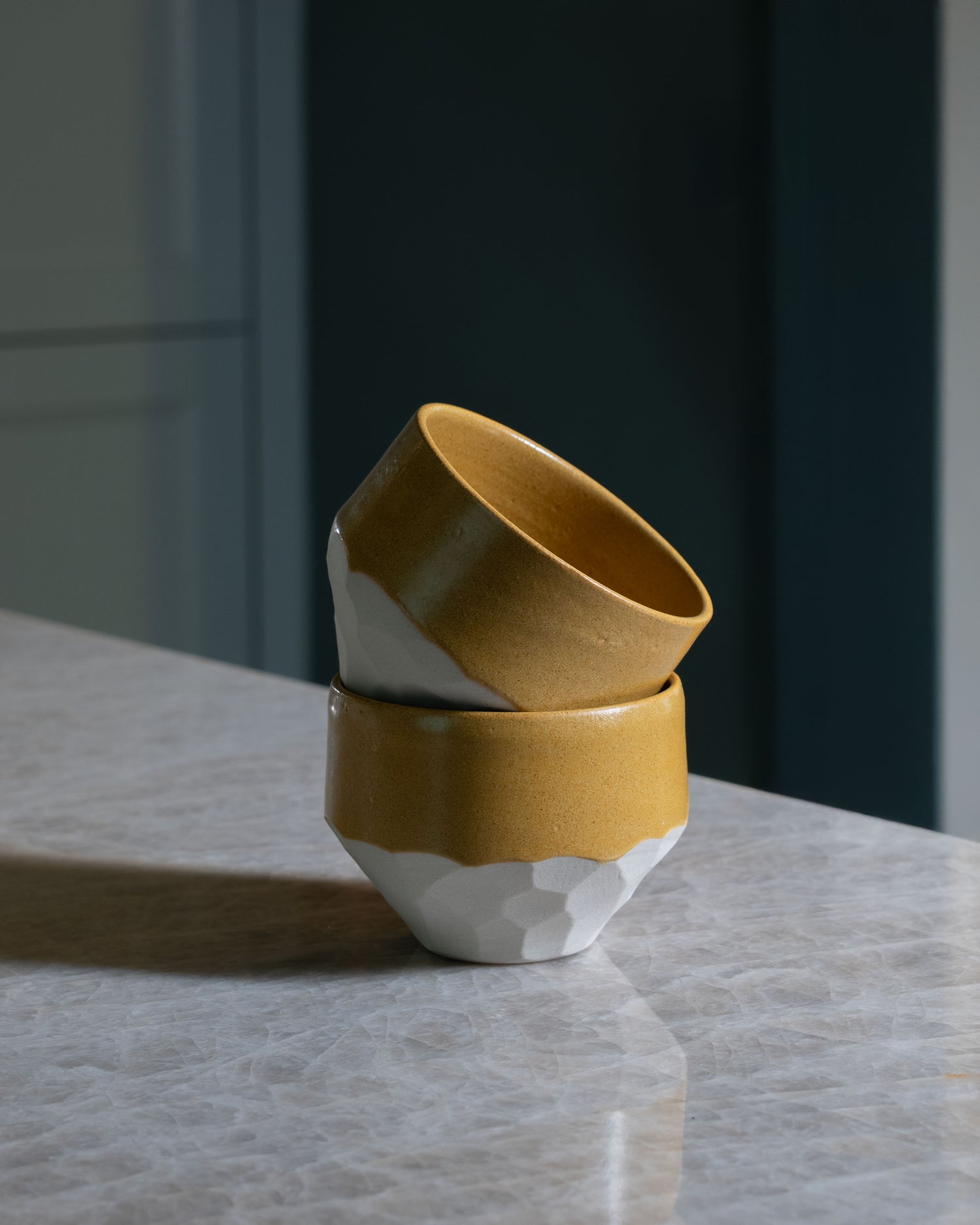 Handmade kurinuki stoneware cappuccino cup in mustard yellow glaze, sculptural ceramic crafted in France by Mestiers.